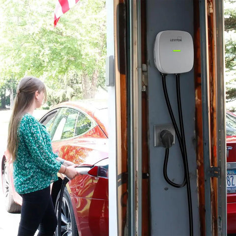 Heavy Duty 50 Amp EV Charging Receptacle NEMA 14-50R installed in garage with user connecting vehicle.