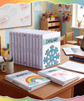12 Pack 1 Inch 3 Ring Monthly Binder Set For Teachers, Classroom Organizer with Seasonal Month Labels on a desk