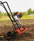 Person using Backyard Ready 31cc 4 Stroke Tiller Cultivator with Four Steel Adjustable Front Tines in garden, EPA Certified, Orange