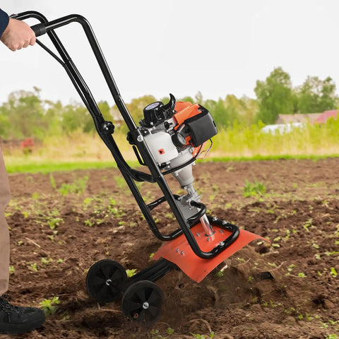 Person using Backyard Ready 31cc 4 Stroke Tiller Cultivator with Four Steel Adjustable Front Tines in garden, EPA Certified, Orange