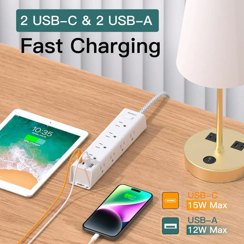 Power Strip With 12 Wide Outlets And 4 USB Ports, 10 Ft Flat Plug Extension Cord shown on desk with devices charging