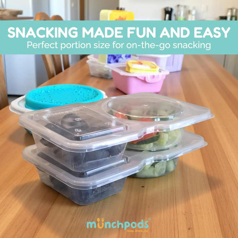 Two Compartment Reusable Snack Containers With Lids 20 Pack on a table, showcasing leak-proof and stackable design with snacks inside.