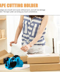 Semi Automatic Heat Tape Cutter With Compact Desktop Packing Station And Lightweight Tape Holder For Quick Box Sealing And Top Shelf Shipping Hustle The Reliable Gadget For Smooth Tape Dispensing Routine Blue on a table in use with packages.