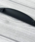 Matte Black Cup Drawer Pull Cabinet Door Handle For Dresser And Vanity Modern Kitchen Hardware on wood surface