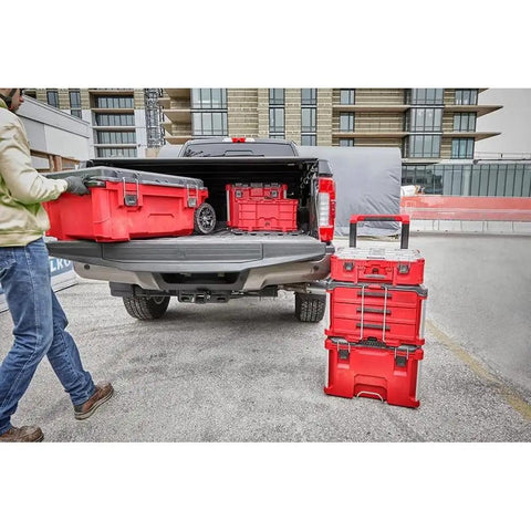 Person loading a red Three Drawer Tool Box With Locking Security Bar For Secure Closure into a truck.