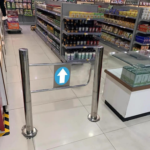 No Sweat Self Closing Security Gate With Spring Hinged Post Mount For Indoor Or Outdoor Use, 90 Degree Swing Entrance Door For Retail Or Home Spaces, Easy One Way Access In Sleek Silver at a store entrance.