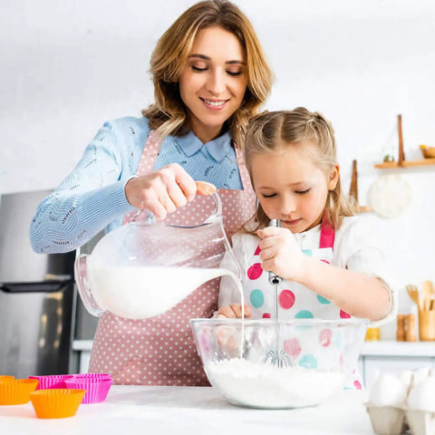 Woman and child using Stainless Steel Hand Push Rotary Whisk Blender Semi Automatic Kitchen Tool For Beating Eggs, Whipping Milk, Frothing Cream And Stirring