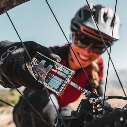 Cyclist using Go To All In One Bike Repair Tool With Tubeless Kit And Chain Breaker, Heavy Duty Stainless Steel Build on MTB.