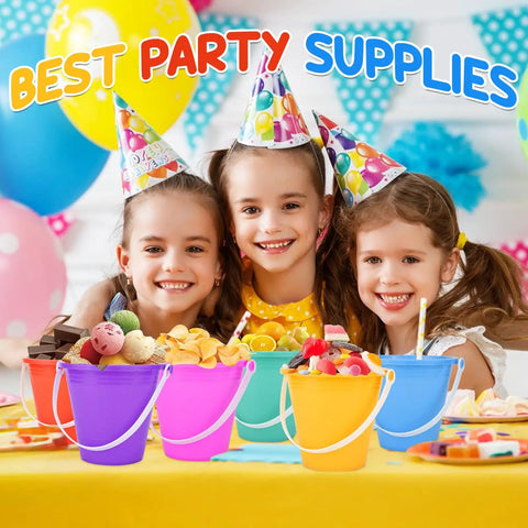 Three kids with party hats smiling behind 12 Pack 5 Inch Beach Buckets and Shovels Set for Kids in colorful shades on a party table.