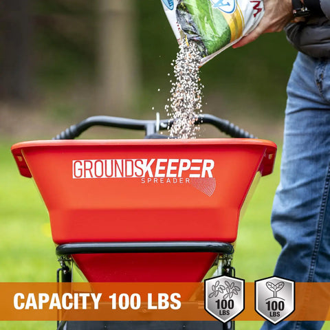 Grounds Keeper All Season Walk Behind Spreader For Seed Fertilizer And Winter Salt With 100 Lb Hopper Capacity in use outdoors