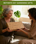 Woman gifting garden tool box labeled 'Garden Tools' to an elderly woman, smiling in a room filled with plants.