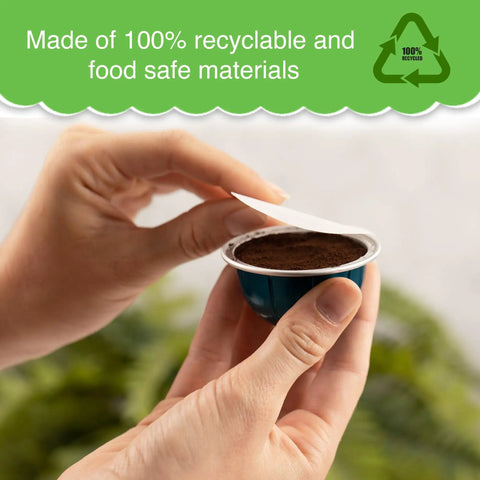 Hands holding coffee pod with paper filter and reusable cap for Nespresso VertuoLine brewers with eco-friendly label.