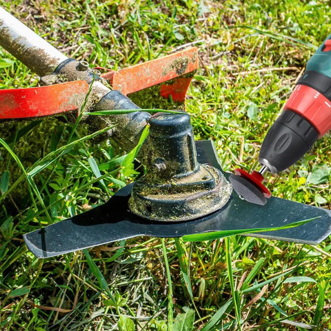 A power drill sharpening a lawn mower blade with the Dull Lawn Mower Blade Sharpener Kit 2024 Upgraded Universal Blade Sharpeners.