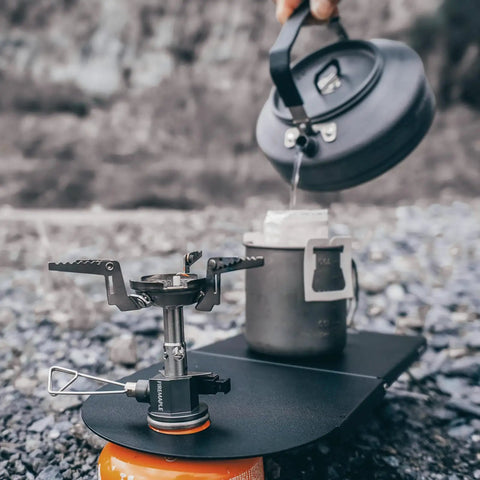 Featherweight Ultralight Folding Camp Table for Solo Camping and Backpacking with stove and kettle setup, black aluminum.
