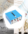 Pro Grade 390W Electric Spot Welder Kit with blue casing, placed among various jewelry items and metal structures.