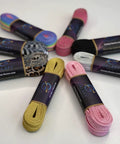 Reflective Pink Roller Skate Laces, 96 Inches Long among assorted colorful lace packs on a table, built tough and flexible