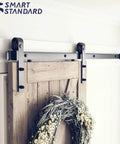 Heavy Duty Sliding Barn Door Hardware Kit For 30 Inch Wide Door Panel Black Finish With J Shape Hangers installed view