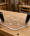 Clear Acrylic Router Base Plate With Reinforced Dual Handles For Compact Routers Rock Solid Stability And Smooth Sailing Cuts For Fine Woodworking Enthusiasts Knockout Clarity on wooden workbench.
