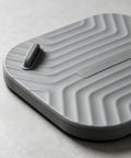 Shower Drain Cover Tub Stopper Square Silicone Floor Drain Cover in gray, showcasing flexible textured design and a handle.