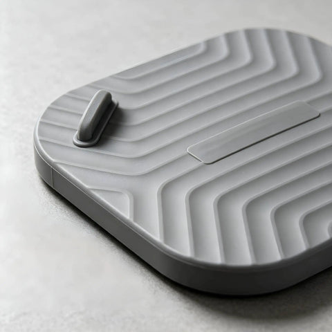Shower Drain Cover Tub Stopper Square Silicone Floor Drain Cover in gray, showcasing flexible textured design and a handle.