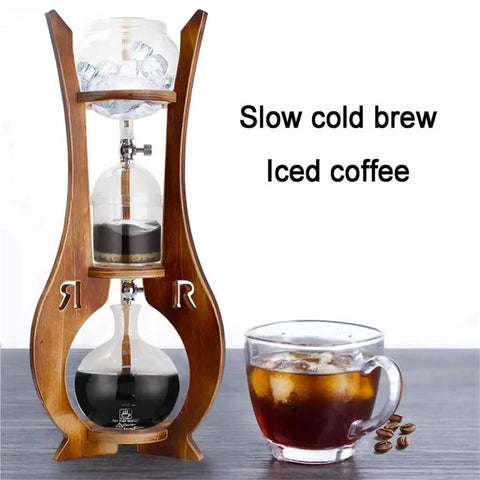 Portable Cold Brew Drip Tower With Smooth Flow Dial And Hefty 1000 Milliliter Pitcher For Chilling Bold Iced Coffee Creations And Nitro Blends While You Kick Back And Enjoy Every Single Cup, shown with iced coffee and wood frame.