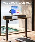 Spacious 40 X 24 Electric Standing Desk With Two Drawers And Hooks, Height Adjustable Computer Workstation C Clamp Mount Home Office Ergonomic Sit Stand Table Walnut with mounted monitor.