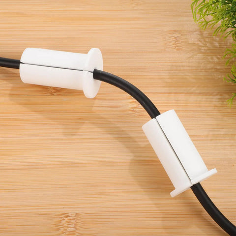 Two Pack Silky Soft Silicone Wall Cable Grommets Kit With Removable Design For Gaming Setups And Entertainment Units To Keep Wires Protected From Fraying And Damage In Sleek White Style, two white silicone cable grommets on black cord