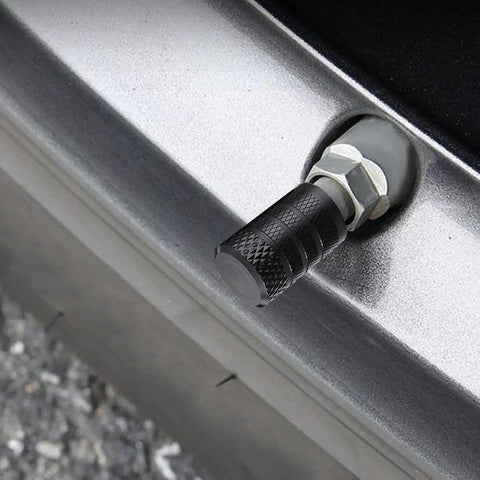 Heavy Duty 4 Pack Tire Valve Stem Caps For Tesla Cybertruck 2024 Through 2026 on a silver wheel valve close-up.