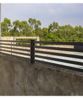 Rock Solid Horizontal Aluminum Deck Railing Featuring A Clean Matte Drip And Fully Custom Backyard Extenders For Patios Balconies Stone Walls And Bulletproof Outdoor Fence Barriers installed on a concrete wall.