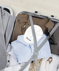 Portable Mini Washing Machine for Road Trips and Compact Laundry in suitcase with clothes and sunglasses for travel convenience.