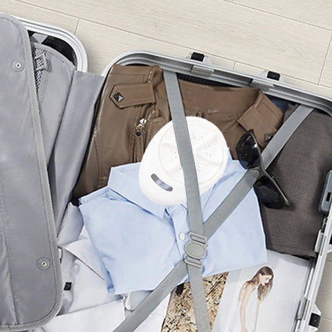 Portable Mini Washing Machine for Road Trips and Compact Laundry in suitcase with clothes and sunglasses for travel convenience.