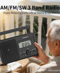 Elderly man holding Go-To Portable AM FM SW Radio With AC DC Power ATS Auto Scan LCD Clock Display USB And SD Card MP3 Player