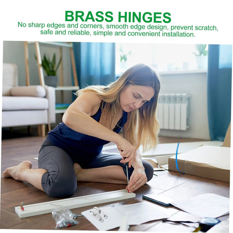 Four-piece metal screw-on interior door hinge kit being assembled on a living room floor.