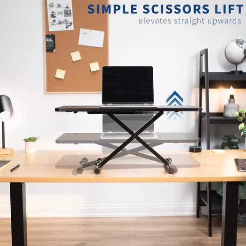 Black 28 Inch Standing Desk Converter Sit To Stand Monitor Riser With Scissor Lift Height Adjustment in home office setup