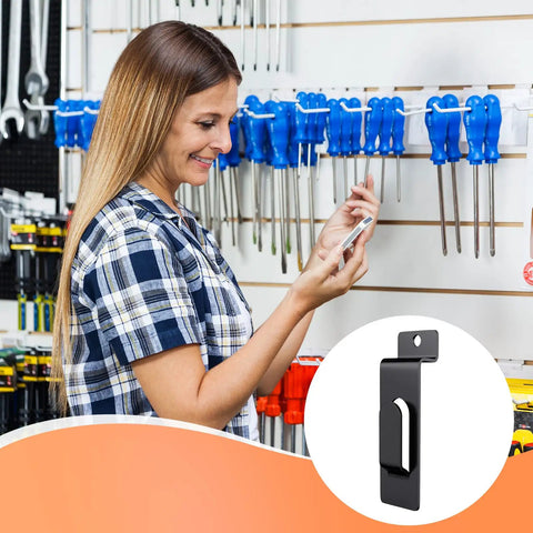 Woman using 20 Pack Slatwall Notch Hooks Heavy Duty Pro Grade Metal Display Hangers For Slat Wall Panels Black Finish in tool shop