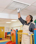 Person adjusting Smooth 39 Inch Aluminum Louvered Ceiling Vent Covers For No Sweat HVAC Air Return Installation in a classroom.