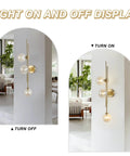 Chic Three Light Globe Glass Wall Sconces With Amber Glass Shades in gold finish, on and off display.