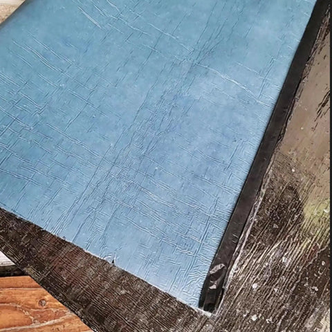 Tough As Nails Bitumen Waterproof Tape With Sturdy Aluminum Foil Backing For Foolproof Rooftop Leak Fixes And Pro Grade Flashing Sealant Roll on wooden surface.