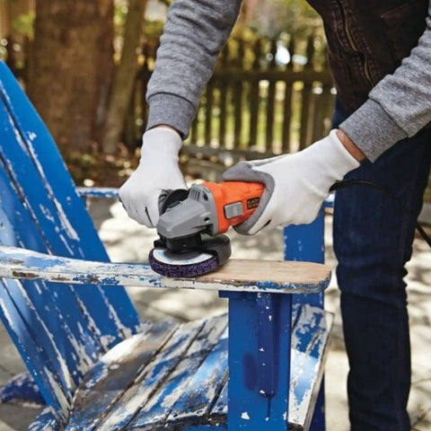 Person using angle grinder with 10 Pack 4.5 Inch Strip Discs Stripping Wheel For Angle Grinder With Seven Eighths Inch Arbor on chair