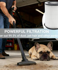 Man using vacuum with attached VF4000 Replacement H13 HEPA Filter for wet dry shop vacuums, cleaning garage floor near dog.