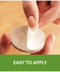 Close-up of hands peeling adhesive backing from Beige 32 Piece Round One Inch Felt Furniture Pads With Self Stick Adhesive Protect Hardwood Floors From Nicks Dents And Scratches While Moving Furniture Like A Pro, showing easy application.