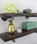 Hella Sturdy Half Inch Industrial Black Iron Pipe Shelf Brackets supporting rustic wooden shelves with decorative items.