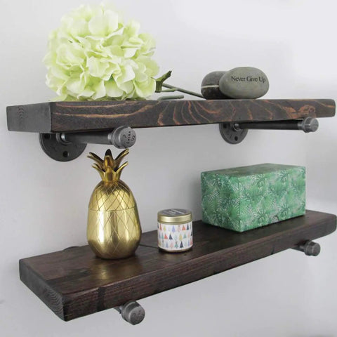Hella Sturdy Half Inch Industrial Black Iron Pipe Shelf Brackets supporting rustic wooden shelves with decorative items.