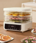 Top Shelf Five Tray Electric Food Dehydrator Featuring Killer 360 Airflow And Smart Controlled Digital Timer To Nail Fresh Fruit Veggies Meat And Healthy Homemade Snacks Daily with sliced fruits on trays.