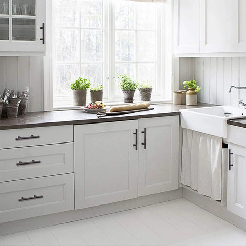Modern kitchen with 20 Pack Oil Rubbed Bronze Solid Cabinet Handles Drawer Pulls 5.38 Inches Long, sleek white cabinetry.