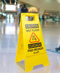 Caution Wet Floor Sign Yellow Double Sided A Frame, Bilingual Foldable Safety Sign 17.12 x 8.38 x 0.94 Inches in a public area