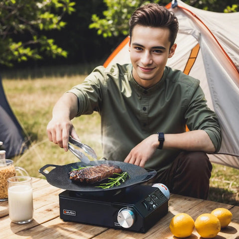 Man cooking steak on Grab And Go Portable Butane Camping Stove With Carrying Case Precise Heat Control For Patio Cooking