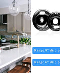 Porcelain drip pan set for electric range 6-inch and 8-inch black replacement fits Whirlpool 4-pack next to kitchen setting.