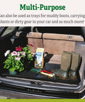 Large Plant Tray Workhorse For Indoor And Outdoor Gardening in car trunk with plants, potting materials, and boots, black tray.
