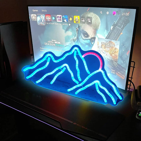 Blue mountain range neon sign on desk with pink sun, LED design for wall decor, perfect for gaming rooms and party vibe.